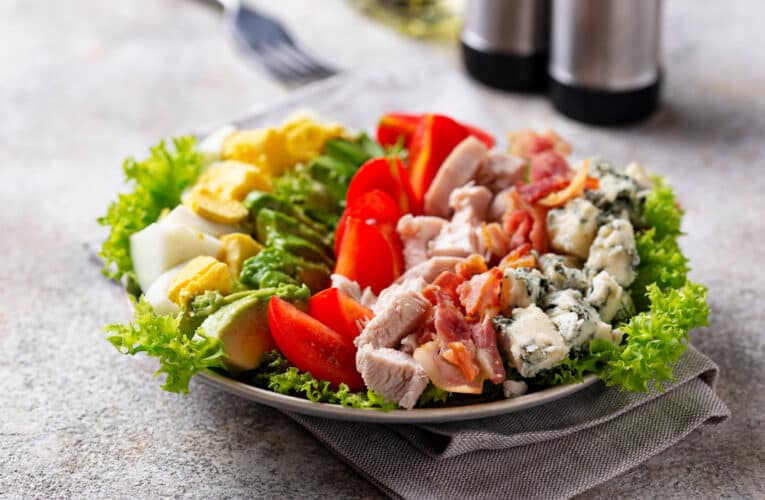 Top view of Cobb salad, traditional American food.