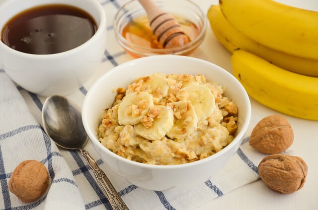 Oatmeal porridge with banana, honey and walnuts, selective focus