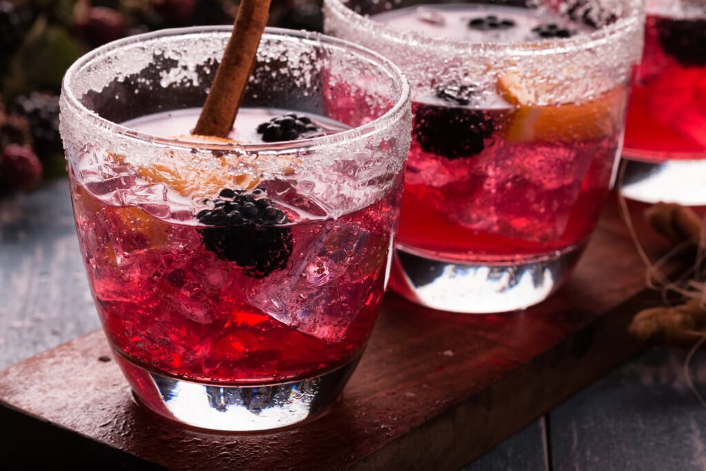 Non Alcoholic Blackberry Drink with fresh Blackberries and slice of orange.