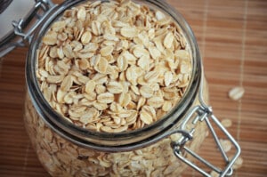 Top view, closeup of Rolled oats or oat flakes in jar.