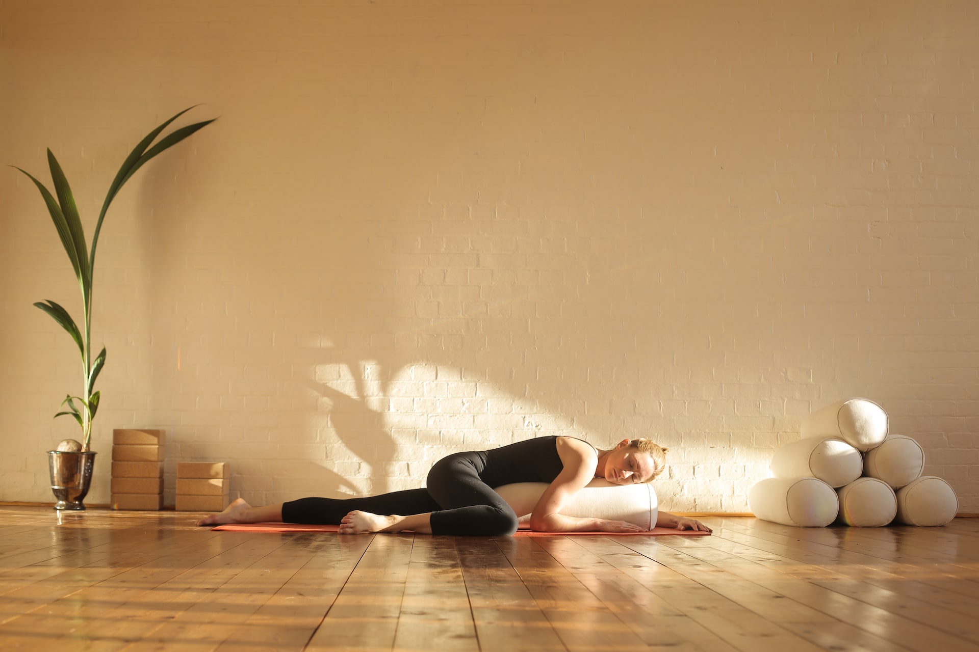 Woman practiving restorative yoga in a beautiful wellness resort